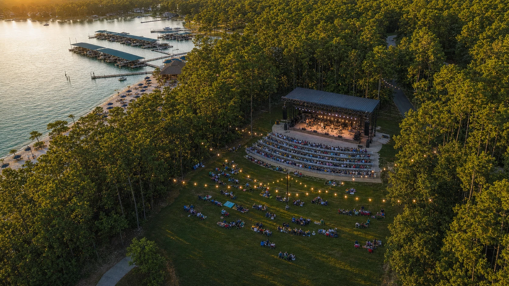 Concept aerial view of a wooded lakeside park, lawn and performance stage