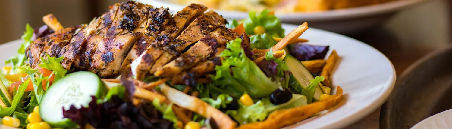 Actual photograph of a grilled chicken salad served at a village clubhouse restaurant