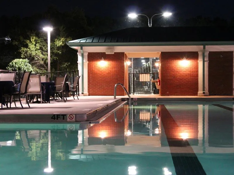 Actual photograph of the outdoor pool and cabana lit up at night